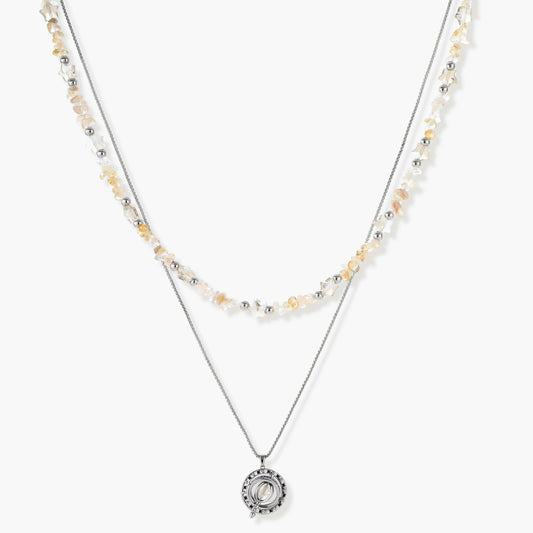 Two-layer necklace with natural stone chips and eco-brass beads, featuring a circular wrapped pendant on cream background.