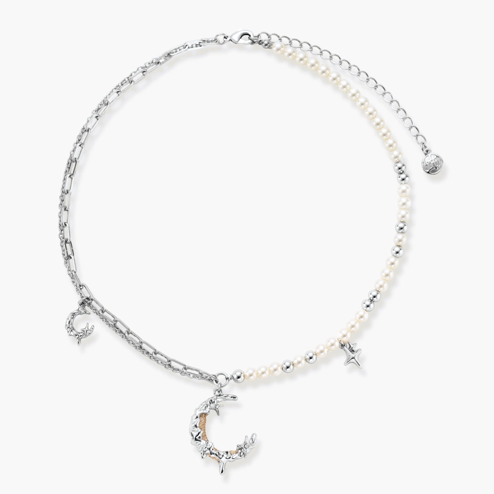 Silver-toned crescent moon pendant with star accents on pearl and chain necklace against white background.