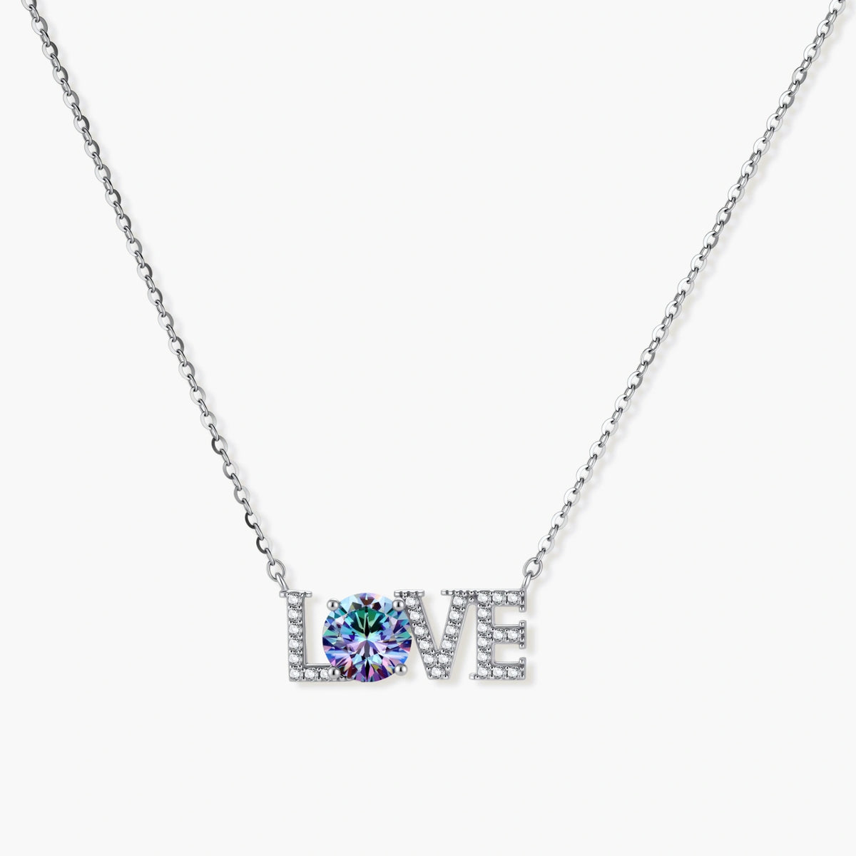 Sterling silver LOVE necklace with brilliant moissanite center stone and pavé details on neutral background.