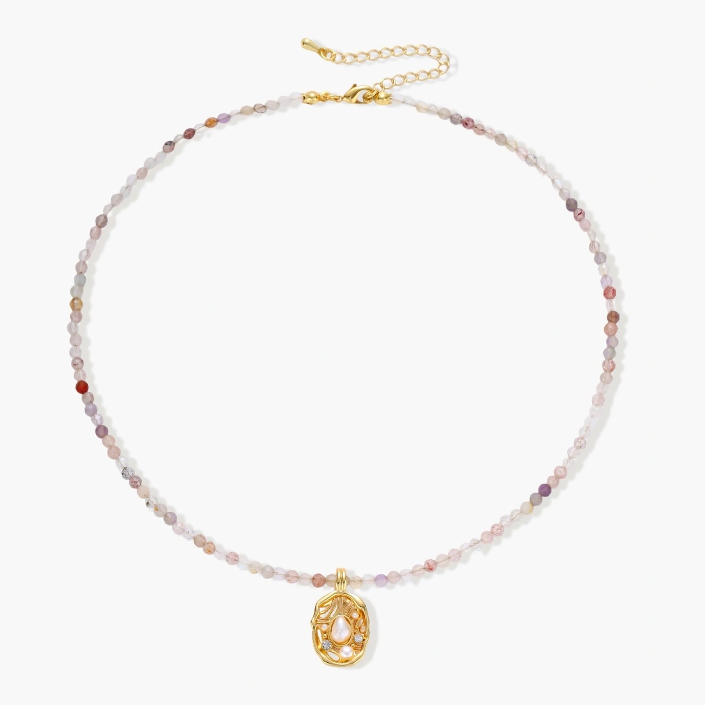 Delicate gold-plated necklace with mixed gemstone beads and ornate oval pendant on white background
