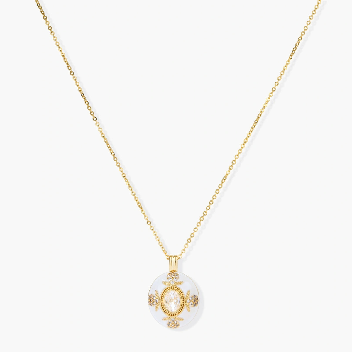 Gold-plated necklace with circular white enamel pendant featuring central zirconia stone and ornate decorative details