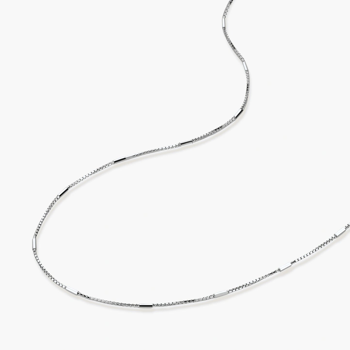Delicate platinum-plated sterling silver necklace with alternating textured cubic links and smooth chain sections.