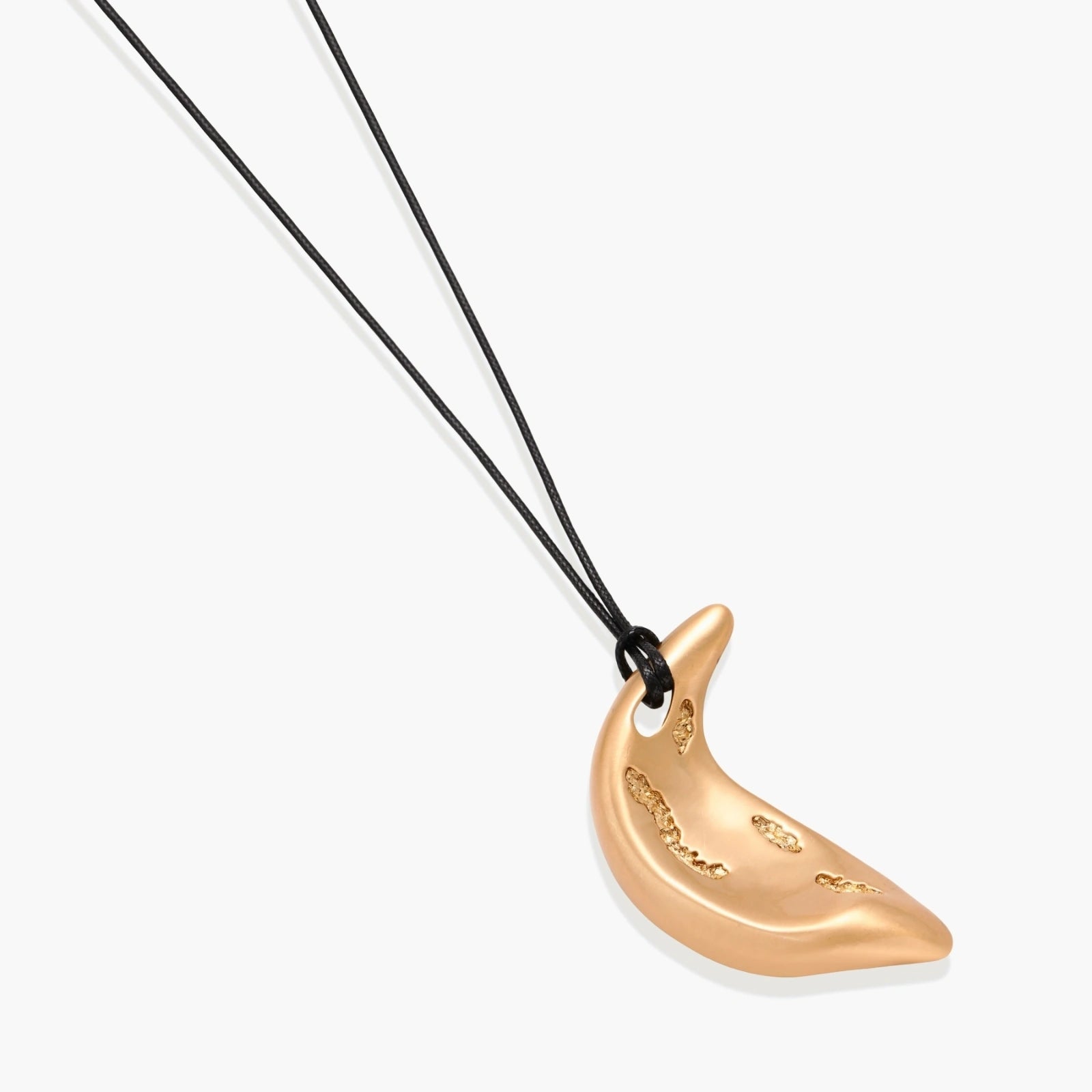 Gold crescent moon pendant with paisley patterns on adjustable black cord with brass beads