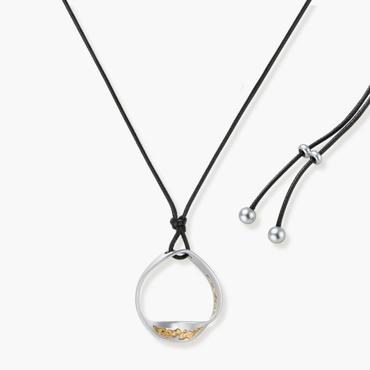 Minimalist silver and gold circle pendant on black adjustable cord, featuring eco-friendly zinc alloy construction